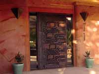 Picture of entry door and sustainable, high mass poured earth walls